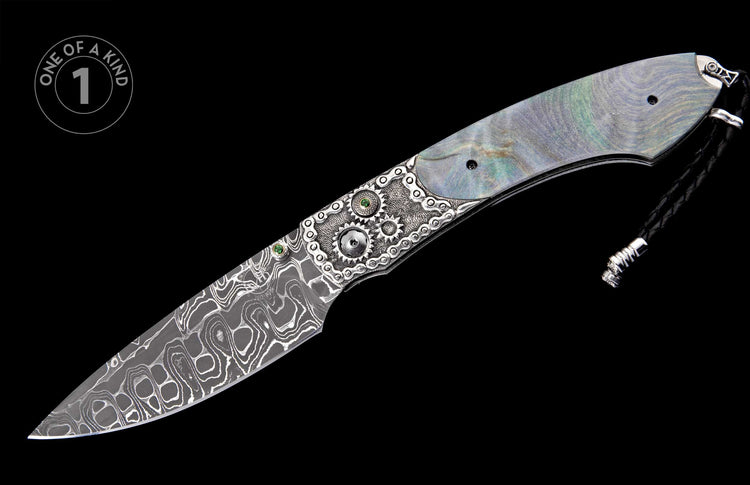 Ornate folding knife with iridescent mother-of-pearl handle, silver gear and chain link details with green gems, wavy Damascus blade, and black lanyard.