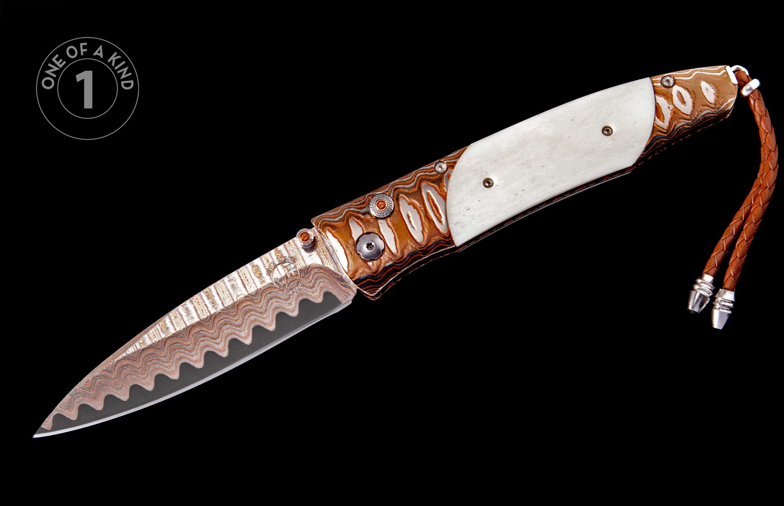 Knife with a wavy Damascus blade, a handle with cream bone, patterned copper-toned sections, orange gem accents, and a braided brown leather lanyard.