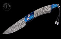 Damascus steel folding knife with a blue anodized titanium handle featuring an engraved bolster, star accent, and braided leather lanyard.
