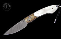 Ornate folding knife with white handle, Damascus blade, gold leaf engraving, blue gemstone accents, and a braided leather lanyard.