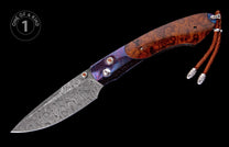 Artisan folding knife with a wavy Damascus steel blade, burl wood and engraved purple metallic handle, and a brown leather lanyard.