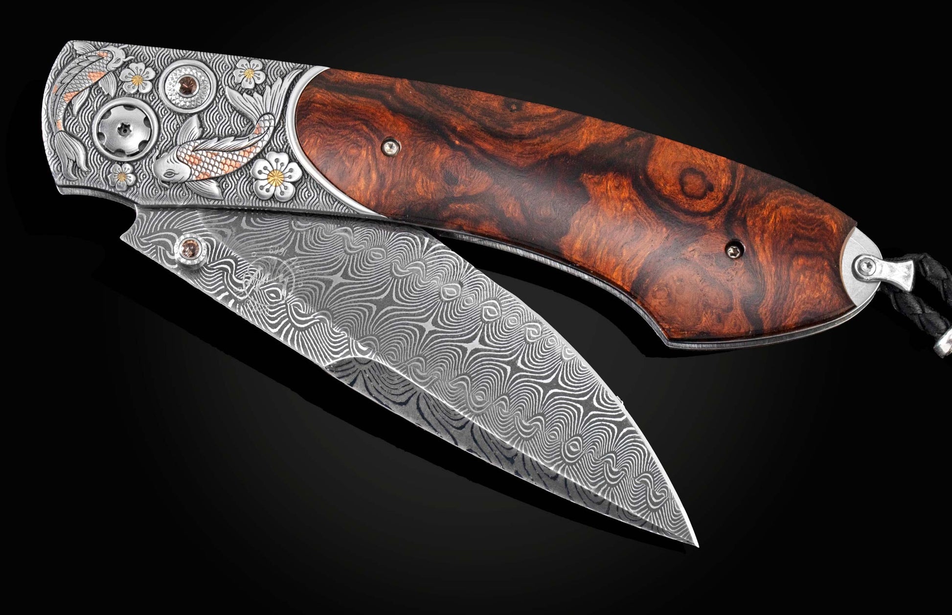 Handcrafted pocket knife from William Henry features hand and laser-engraved koi fish with copper and brass,, inlaid with desert ironwood, smoky quartz gemstones. and a hand forged Damascus steel blade.