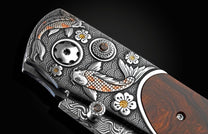 Handcrafted pocket knife from William Henry features hand and laser-engraved koi fish with copper and brass