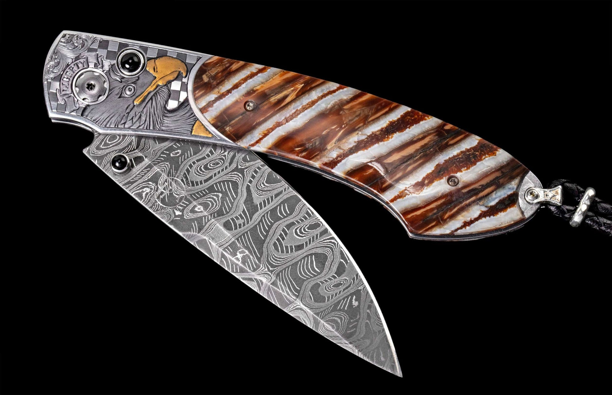 Ornate folding knife with Damascus steel blade, brown and white striped handle, and engraved silver bolsters featuring a bald eagle and "LIBERTY" text.