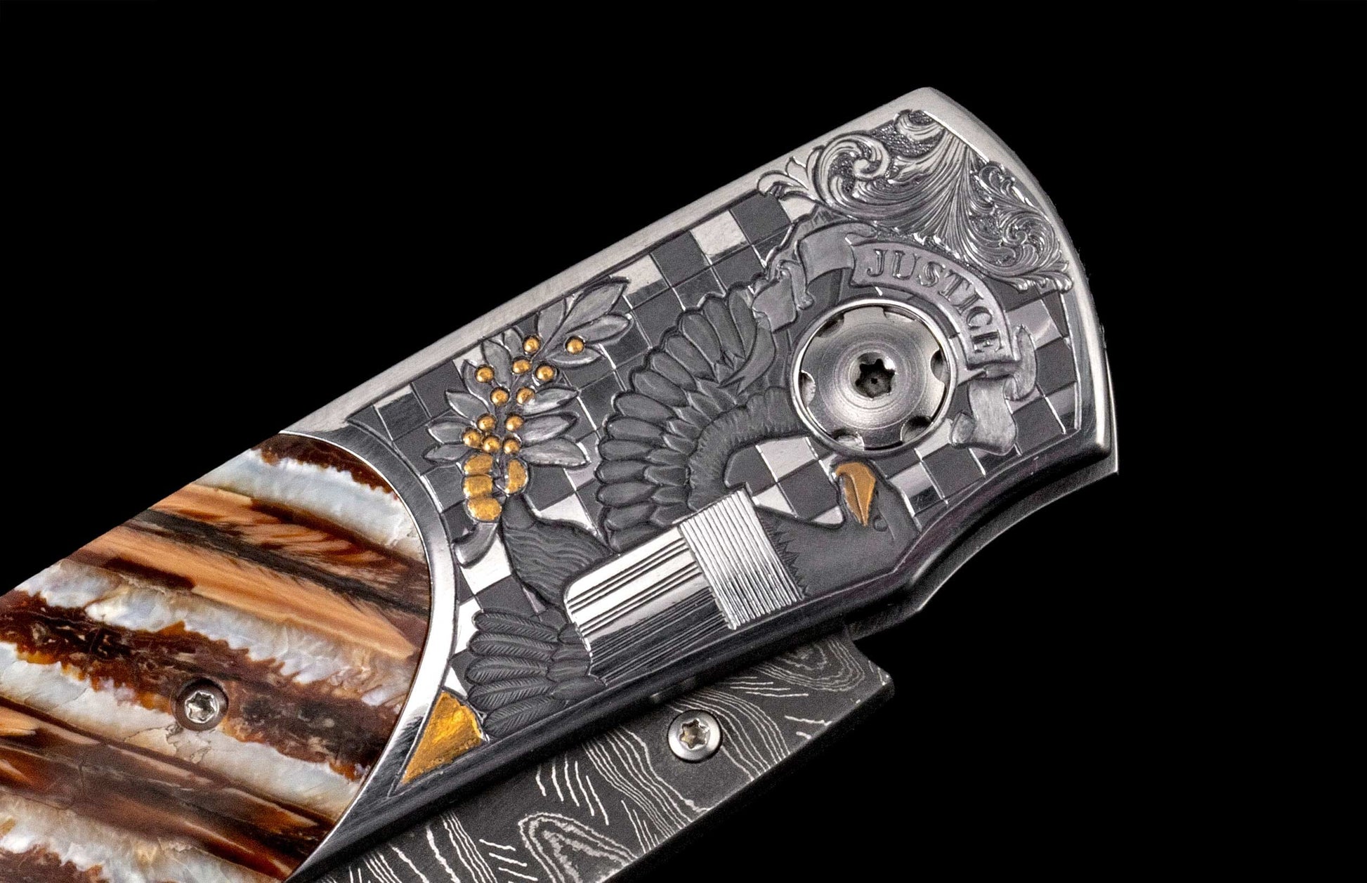 Ornate metal knife with 'JUSTICE' engraved, an eagle, scales of justice, gold accents, and a swirling brown handle.