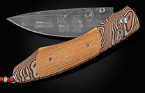 Handcrafted pocket knife from William Henry with a frame of hand-forged 'Twist' mokume by Mike Sakmar, inlaid with wood from the law office of Abraham Lincoln from 1843-1852, set with smoky quartz gemstones and a hand-forged 'Flag' damascus Steel blade.