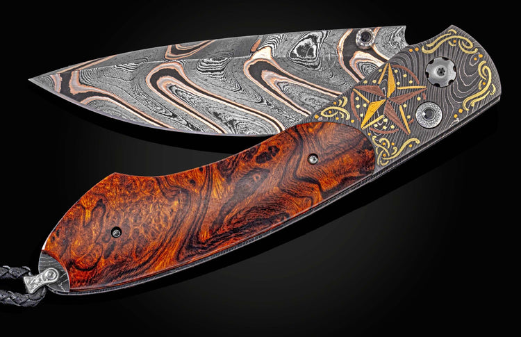 Ornate Lonestar folding knife with swirling Damascus blade, burled wood handle, and engraved star and scrollwork.