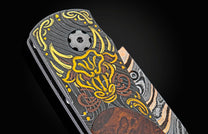 Folding knife with dark Damascus handle, ornate gold and brown design, brown wood inlay, and a patterned Damascus blade.