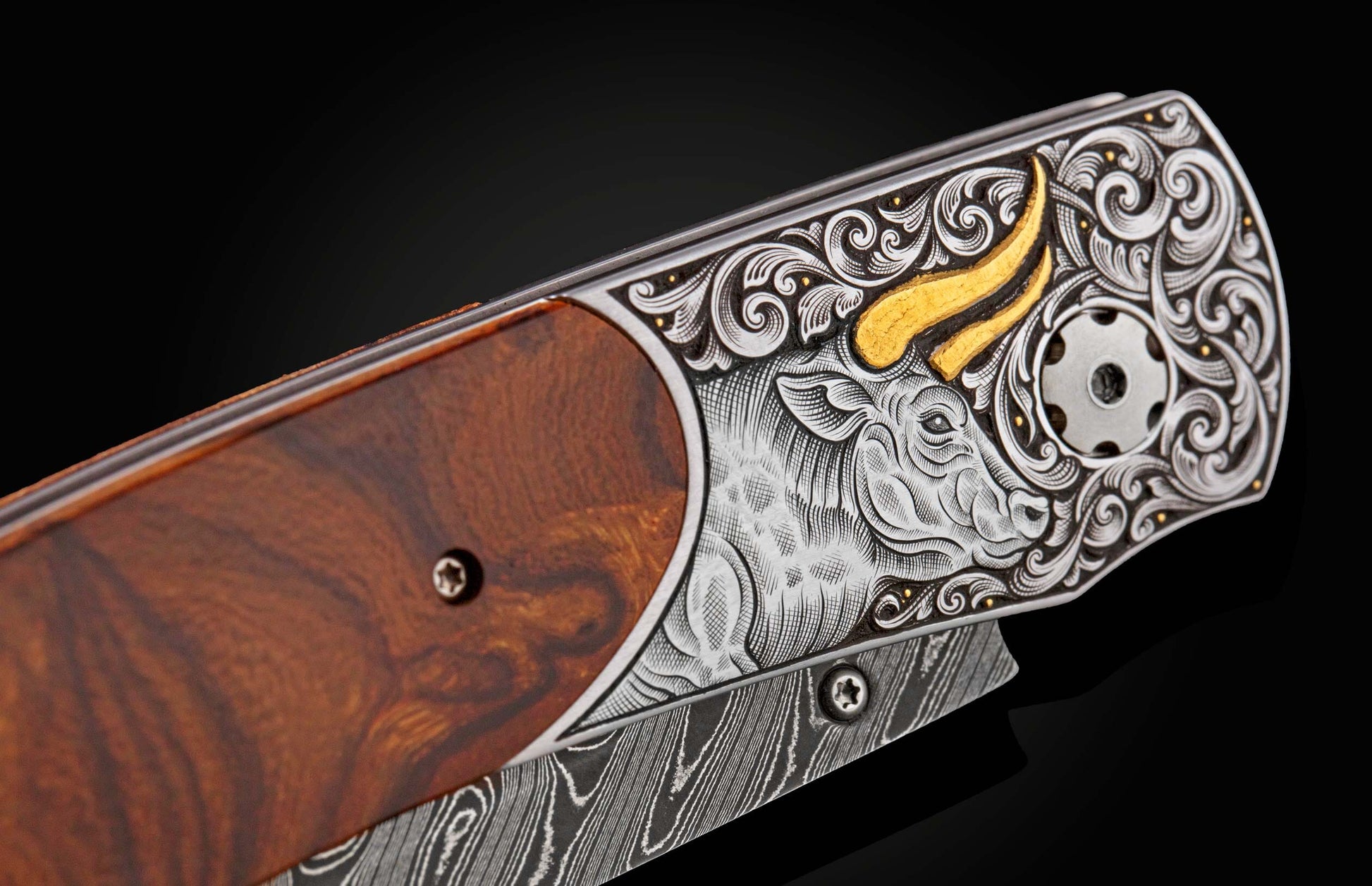 Handcrafted William Henry custom knife with hand-engraved frame with 24K gold inlays depicting a bull by Tyler Prince
