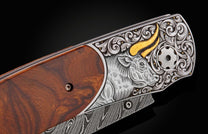 Handcrafted William Henry custom knife with hand-engraved frame with 24K gold inlays depicting a bull by Tyler Prince