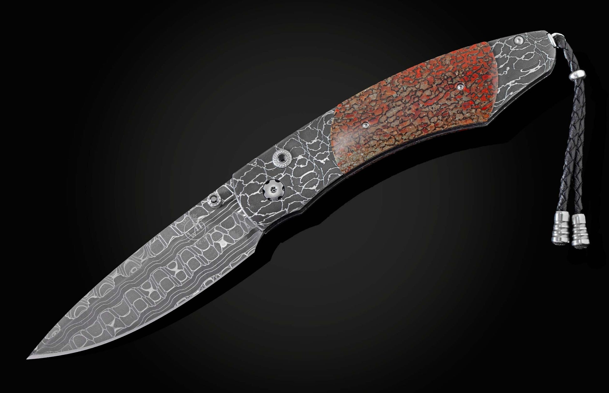 Handcrafted pocket knife from William Henry featuring a frame in hand-forged Damascus steel
