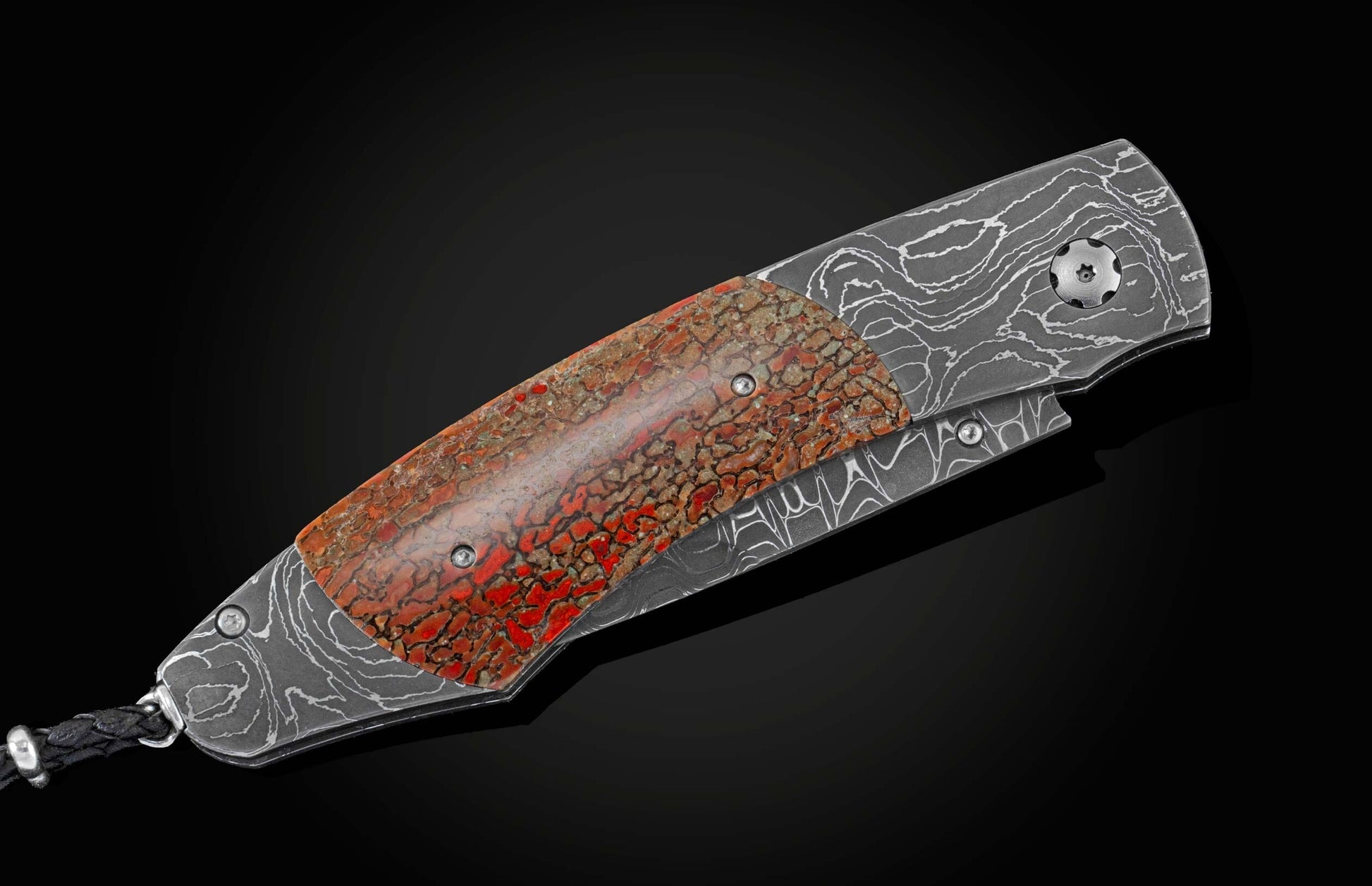  inlaid with a mesmerizing piece of fossil dinosaur bone (from an Apatosaurus that walked the Earth 100 million years ago). The blade is hand-forged Damascus steel