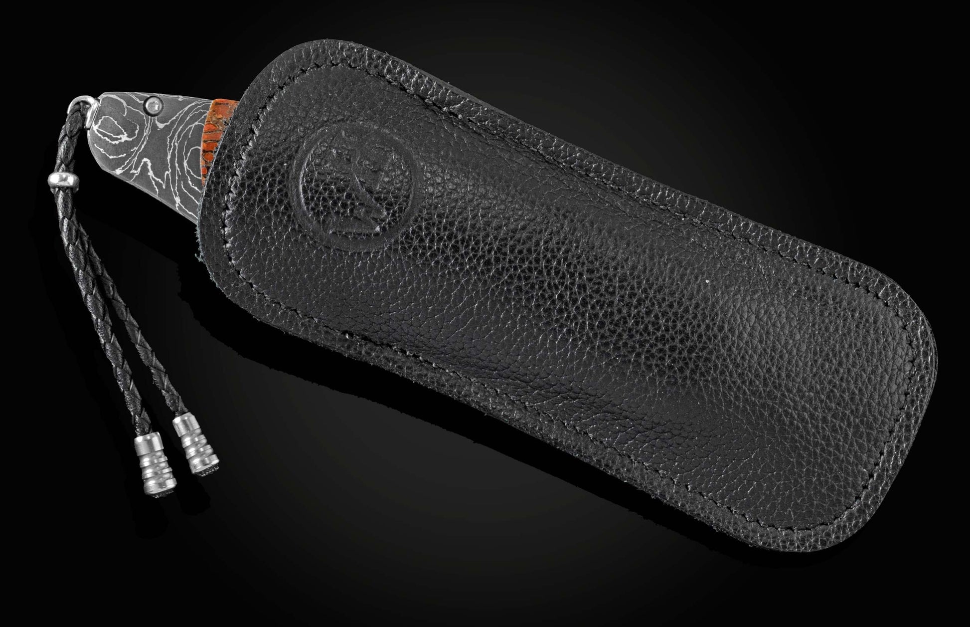 Handcrafted pocket knife from William Henry featuring a frame in hand-forged Damascus steel