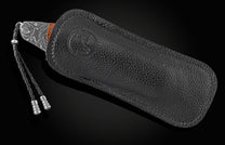 Handcrafted pocket knife from William Henry featuring a frame in hand-forged Damascus steel