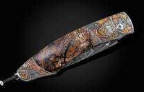  copper and tombac inlays. Scales inlaid with fossil Woolly Mammoth tusk. The blade is hand-forged Damascus steel and the button lock and thumb stud ar
