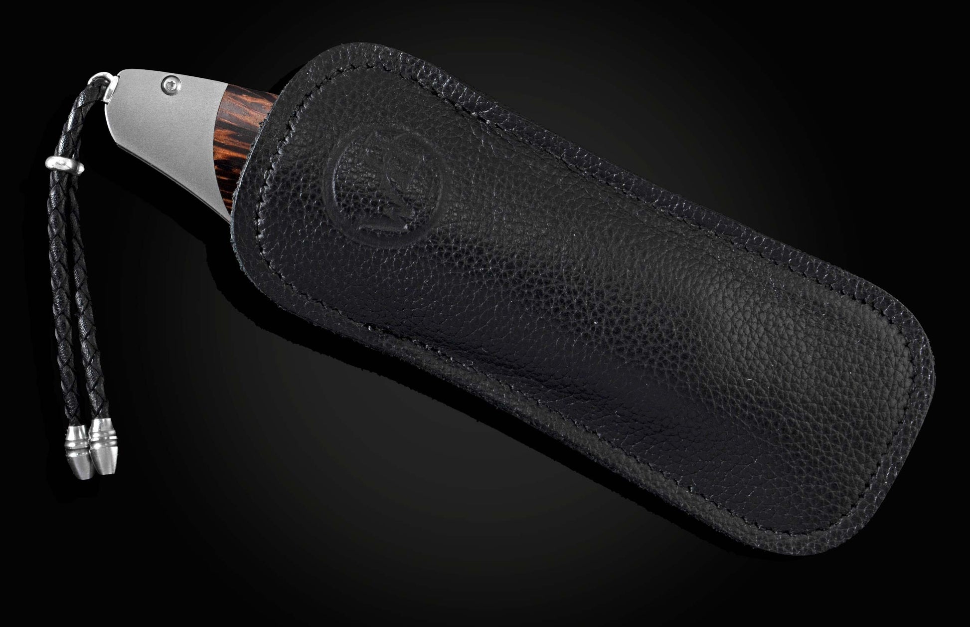 Handcrafted pocket knife from William Henry features a titanium frame inlaid with beautiful Black Palm wood and set with spinel gemstones and a hand forged Damascus steel blade.