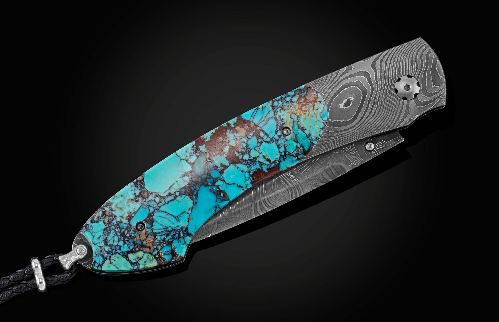 Handcrafted pocket knife from William Henry with a frame in hand-forged Damascus steel inlaid with black Matrix Kingman turquoise and set with garnets. The blade is hand forged damascus steel