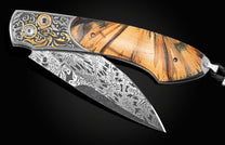 Handcrafted pocket knife from William Henry features hand-engraved bolsters with 24K yellow gold
