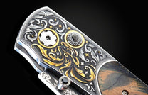  inlaid with fossil Woolly Mammoth tusk and set with spinel gemstones. The blade is hand-forged  damascus steel.