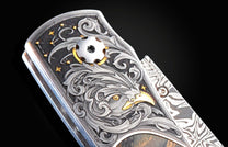 Handcrafted pocket knife from William Henry features hand-engraved bolsters with 24K yellow gold