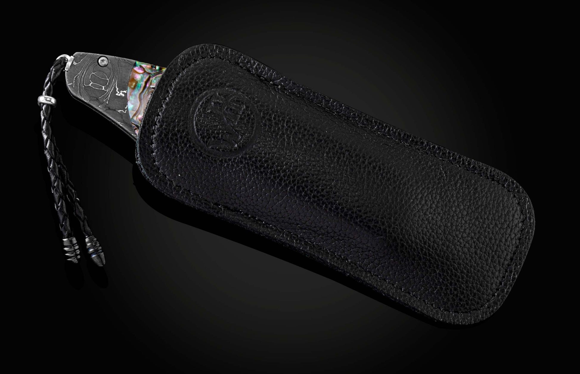 The Rip Tide Folding Knife with Hand-Forged Damascus and Abalone Shell in a leather case