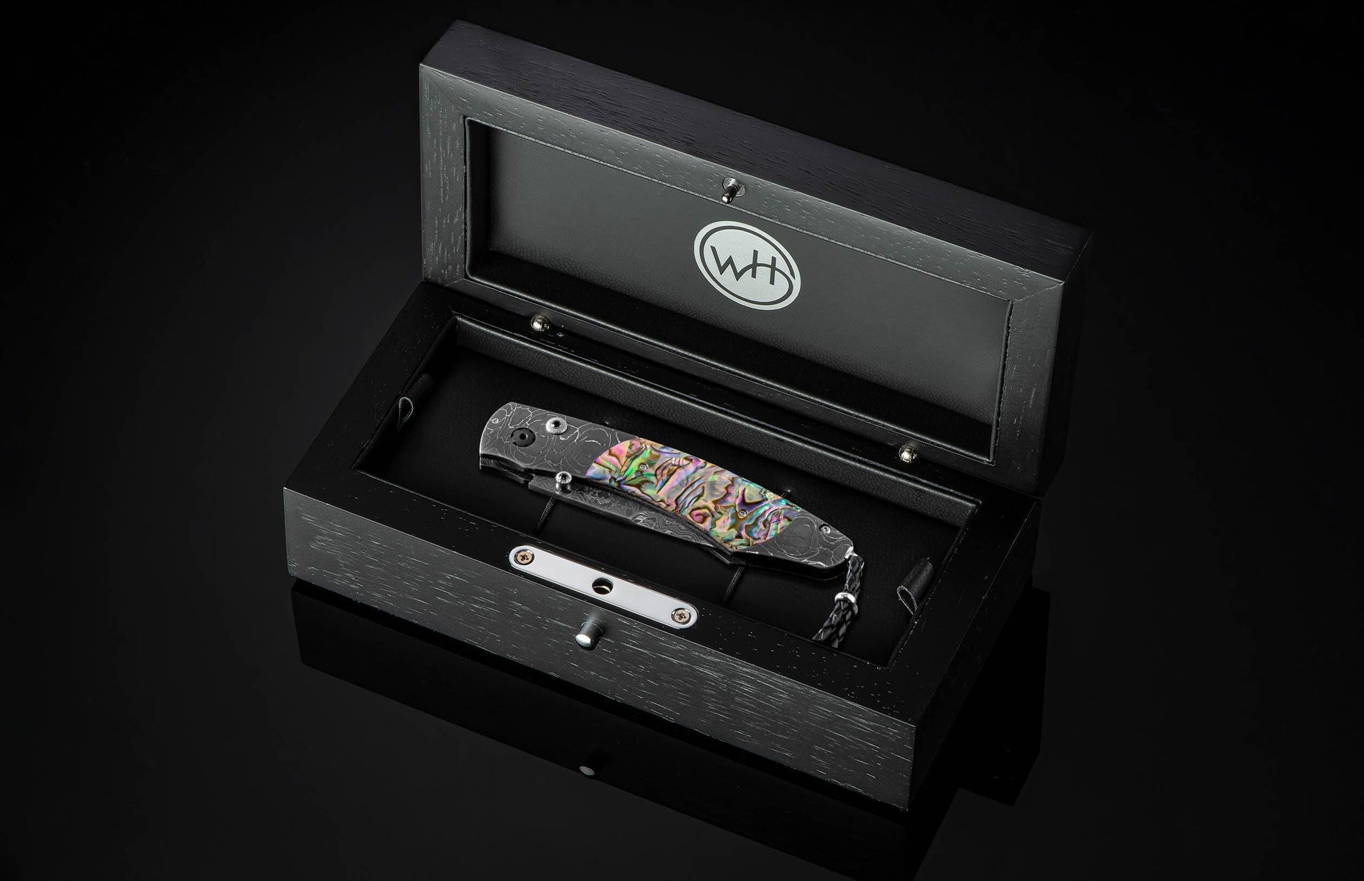 The Rip Tide Folding Knife with Hand-Forged Damascus and Abalone Shell in a case