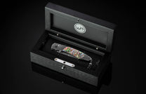 The Rip Tide Folding Knife with Hand-Forged Damascus and Abalone Shell in a case
