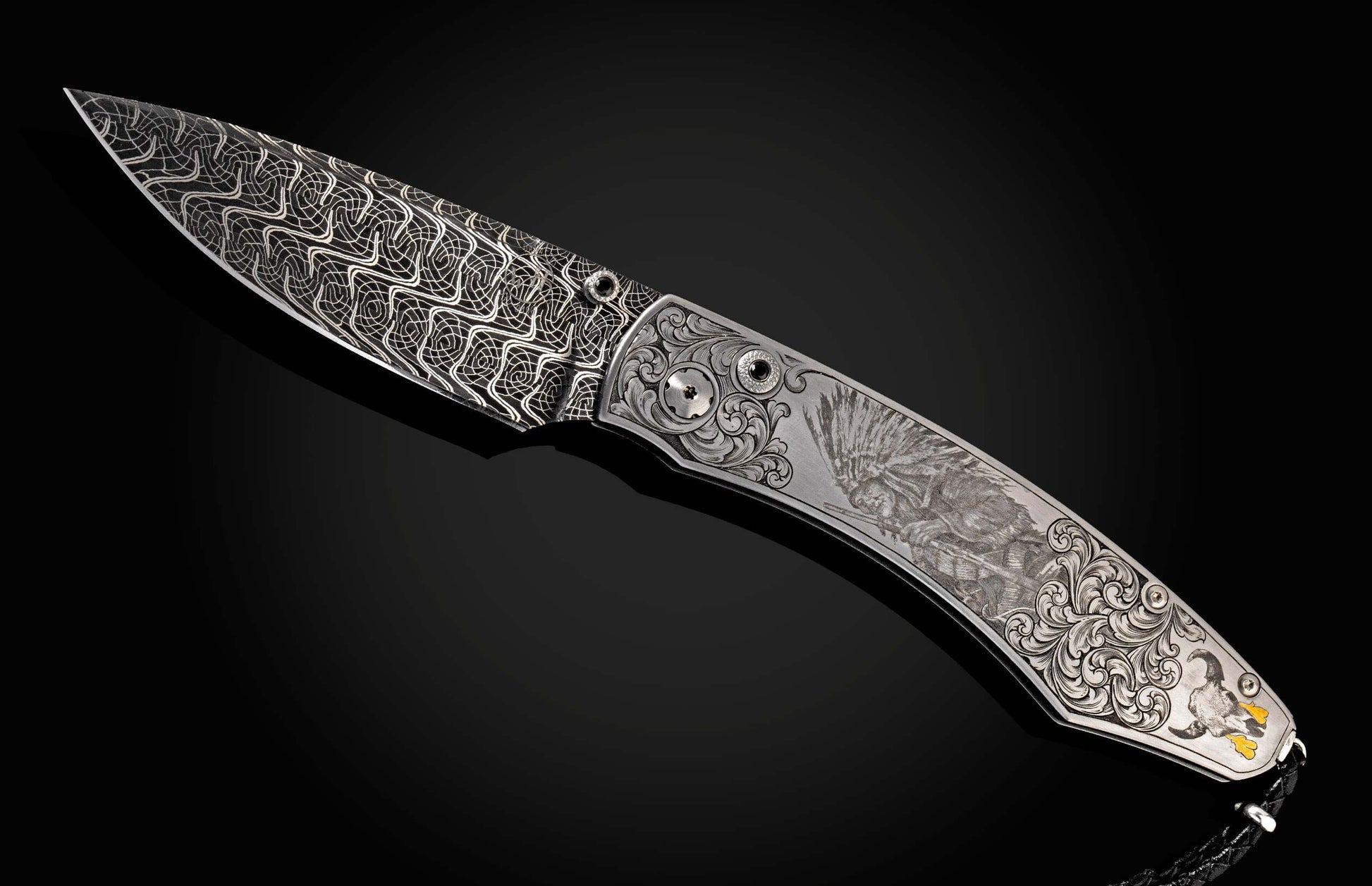 Intricately engraved folding knife with a patterned blade and a Native American chief carving on the handle, on a reflective black surface.