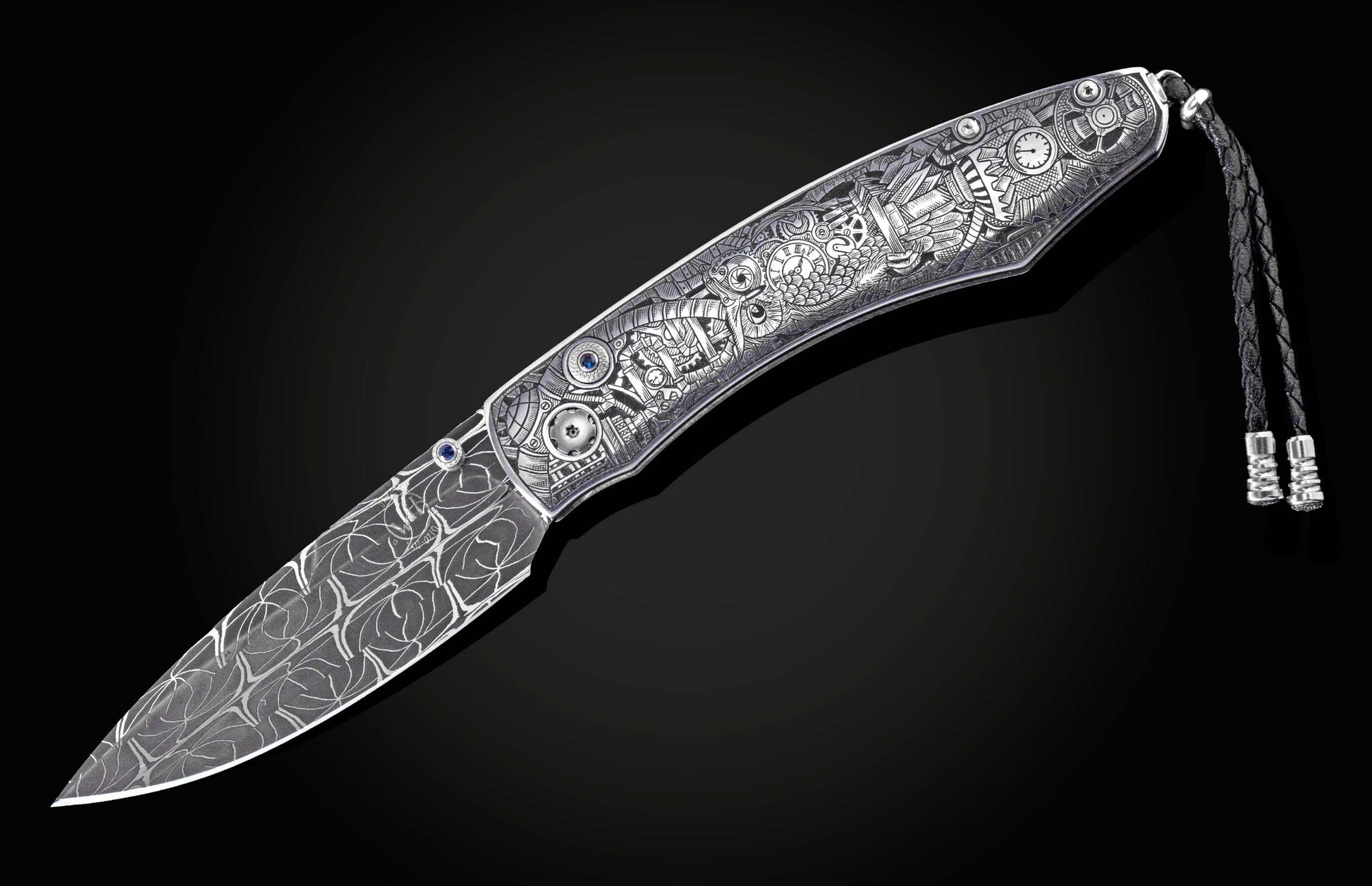 Silver-toned folding knife with intricate steampunk engravings, a patterned blade, blue gemstones, and a braided leather lanyard.