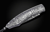 Silver-toned metal knife with intricate Steampunk-style engraving of gears, pipes, and a horned figure, featuring a braided lanyard, angled view.