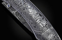 Knife with silver steampunk etching of an owl, gears, and clocks, on a dark Damascus steel handle with a blue sapphire.