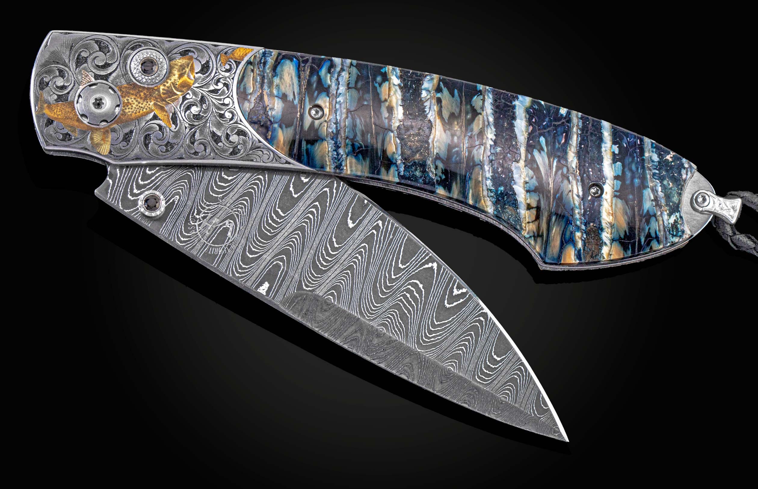 William Henry knife features a hand-engraved bolster with 24K gold, 18K green gold, and silver inlays by Thierry Duguet, fossil Woolly Mammoth tooth, spinel gem stones and hand-forged damascus steel blade with Gibeon Meteorite by Chad Nichols