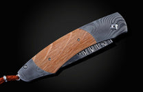 Handcrafted pocket knife from William Henry features a beautiful frame in Damascus steel inlaid with barrel wood from Pappy Van Winkle Bourbon
