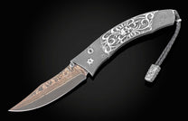  and a hand forged Damascus steel blade by Baker Forge.
