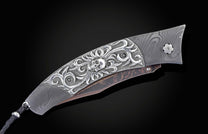 Custom William Henry knife featuring a frame in hand forged Damascus steel by Chad Nichols