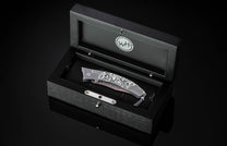  and a hand forged Damascus steel blade by Baker Forge.