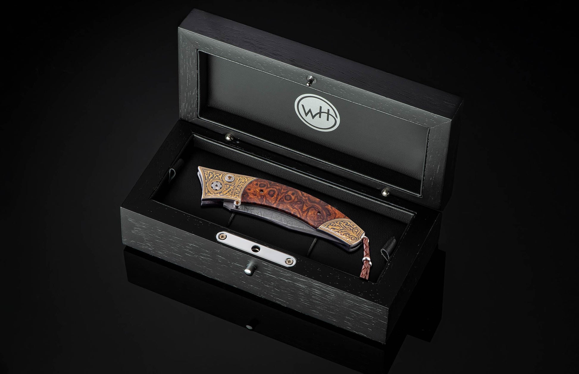  inlaid with desert ironwood. The blade is hand-forged  Damascus steel and the  button lock and the thumb stud are set with citrine gemstones.