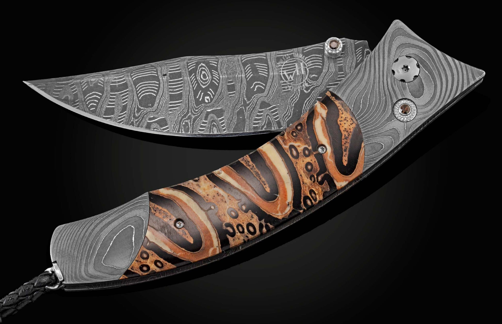 This hand crafted knife from William Henry features a frame in hand forged Damascus steel, inlaid with Ponga Fern wood which grows only in New Zealand. The blade is hand-forged Damascus steel and the button lock and the thumb stud are set with smoky quart