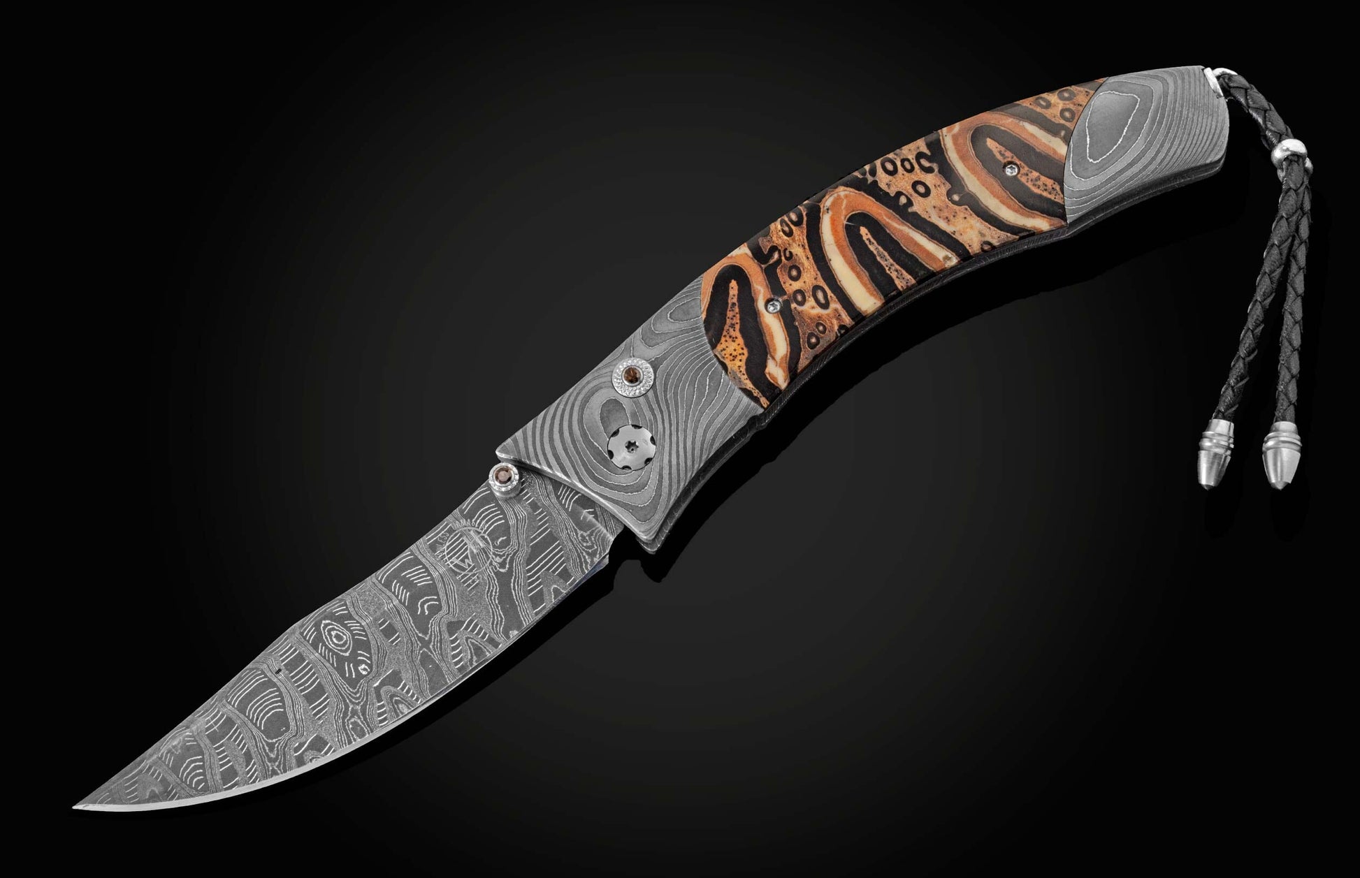 This hand crafted knife from William Henry features a frame in hand forged Damascus steel