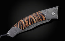  inlaid with Ponga Fern wood which grows only in New Zealand. The blade is hand-forged Damascus steel and the button lock and the thumb stud are set with smoky quart
