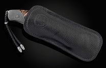 This hand crafted knife from William Henry features a frame in hand forged Damascus steel