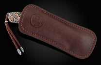 Handcrafted pocketknife from William Henry features a beautiful frame in hand-carved sterling silver with mokume gane