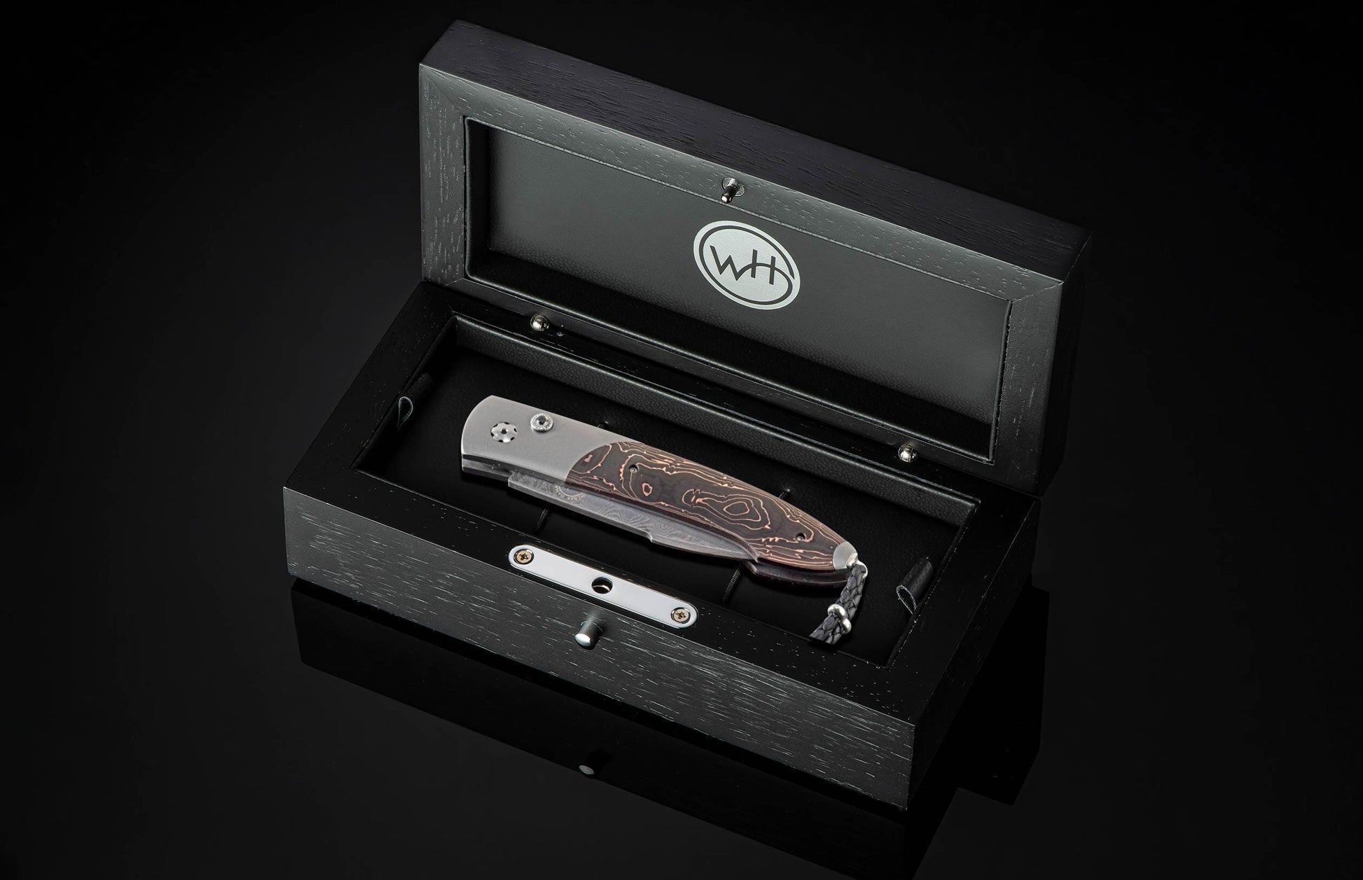 Handcrafted William Henry custom automatic knife features a titanium frame