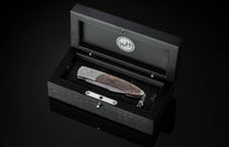 Handcrafted William Henry custom automatic knife features a titanium frame