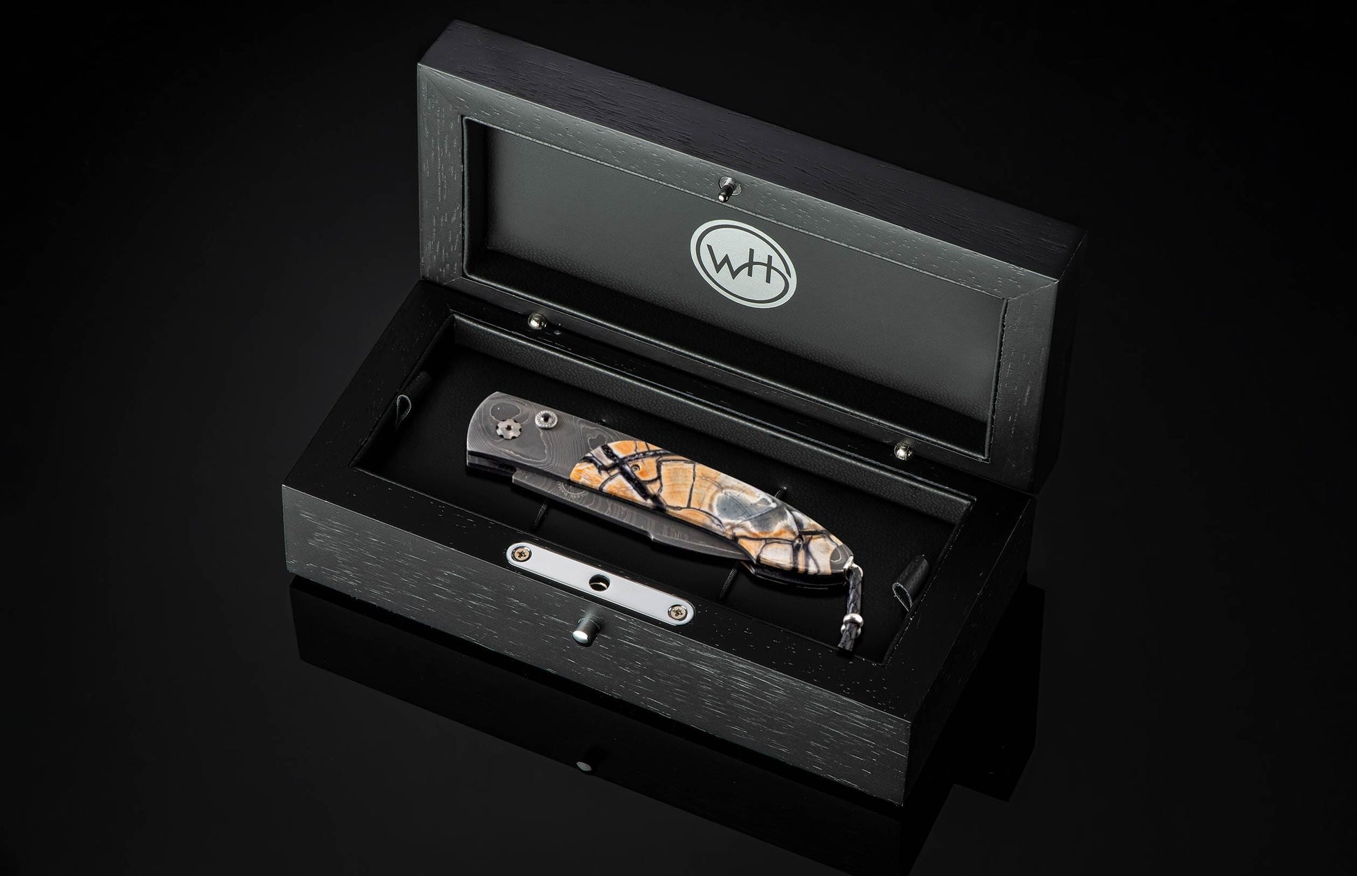 Handcrafted William Henry custom automatic knife features a hand-forged Damascus steel frame by Chad Nichols