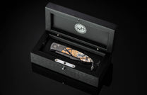 Handcrafted William Henry custom automatic knife features a hand-forged Damascus steel frame by Chad Nichols