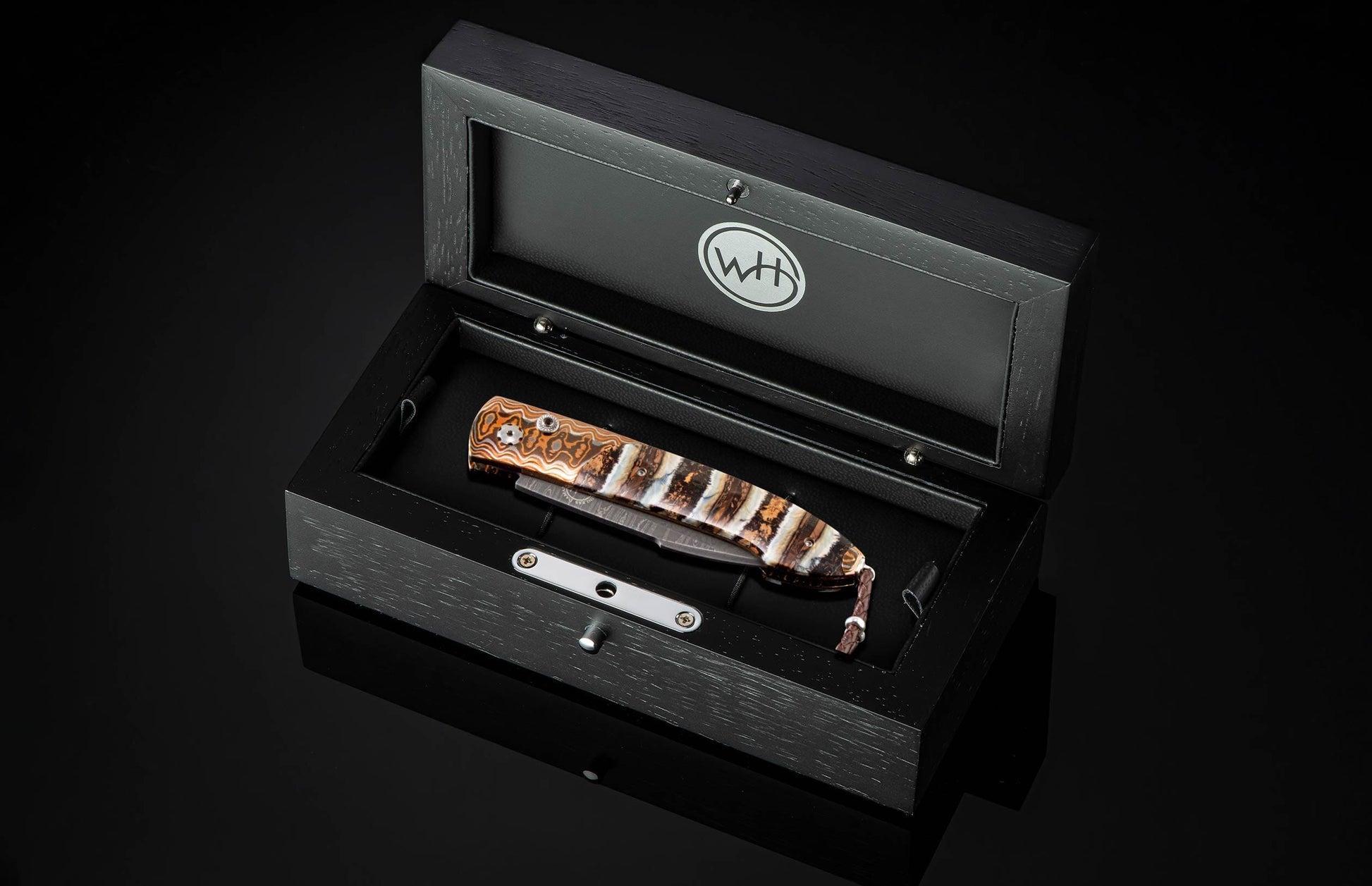 Handcrafted William Henry custom automatic knife features a heat-colored mokume frame