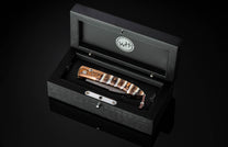 Handcrafted William Henry custom automatic knife features a heat-colored mokume frame