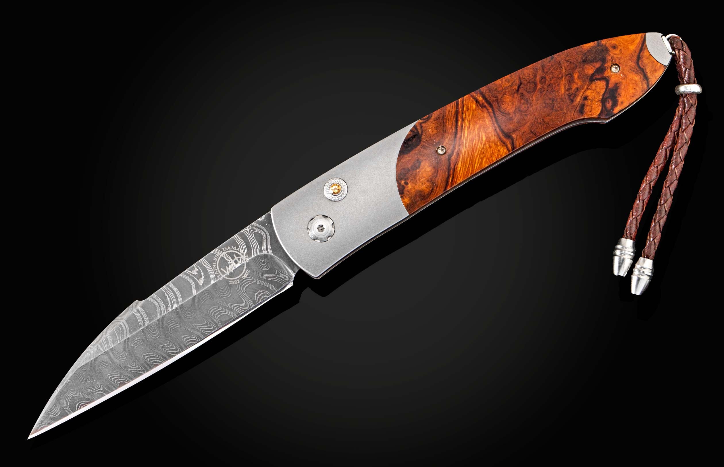 Handcrafted William Henry custom automatic knife features a titanium frame, inlaid with Desert Ironwood scales, citrine gemstones, and a hand-forged Damascus steel blade by Chad Nichols