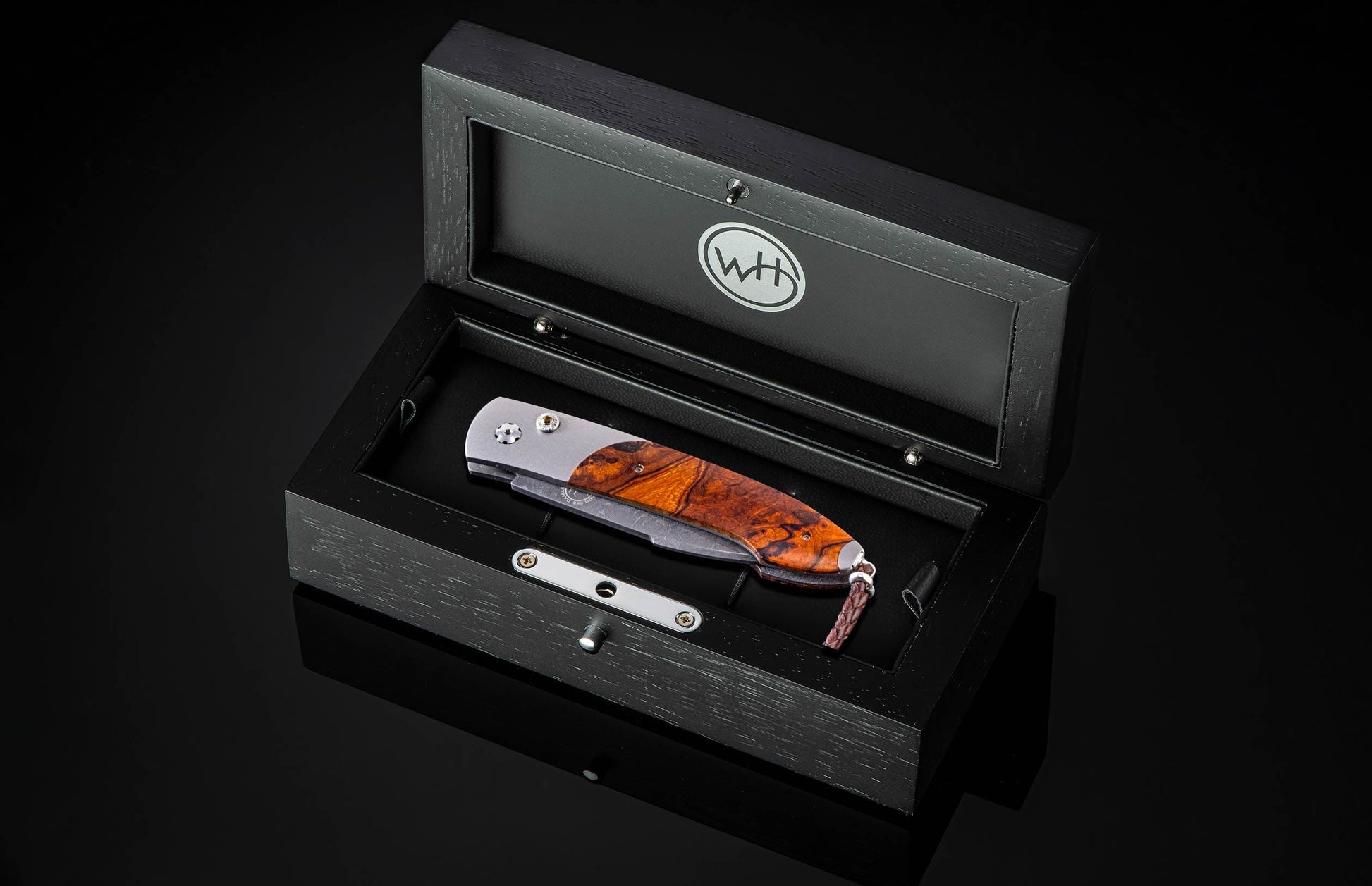 Handcrafted William Henry custom automatic knife features a titanium frame